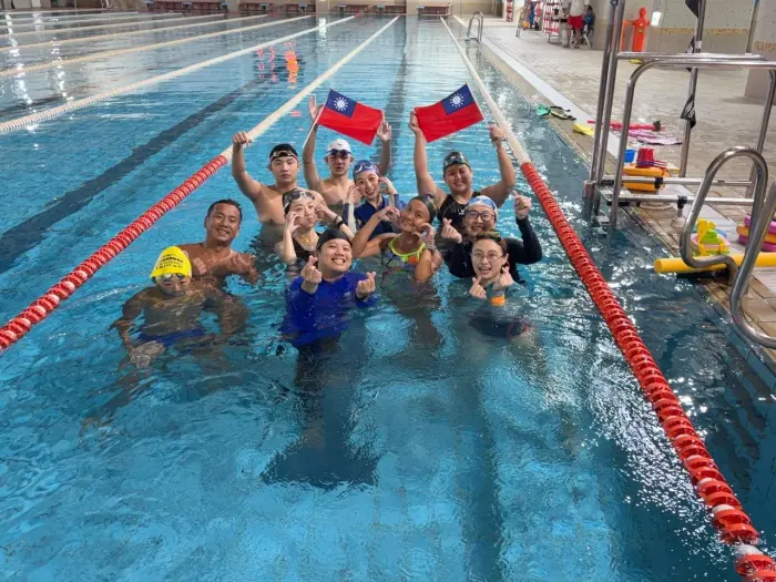 Swim coach trainees celebrating after a training session