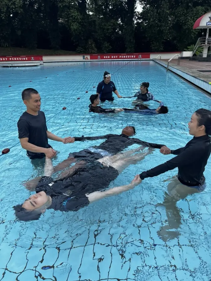 Coaches practising a water rescue technique during the Swim Australia Teacher course