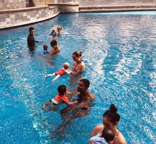 Parents and babies in the water together during a condo group swim class