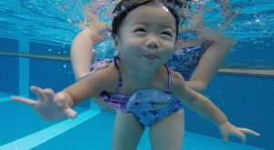 are babies natural swimmers – infant swimming reflex in warm indoor pool Singapore